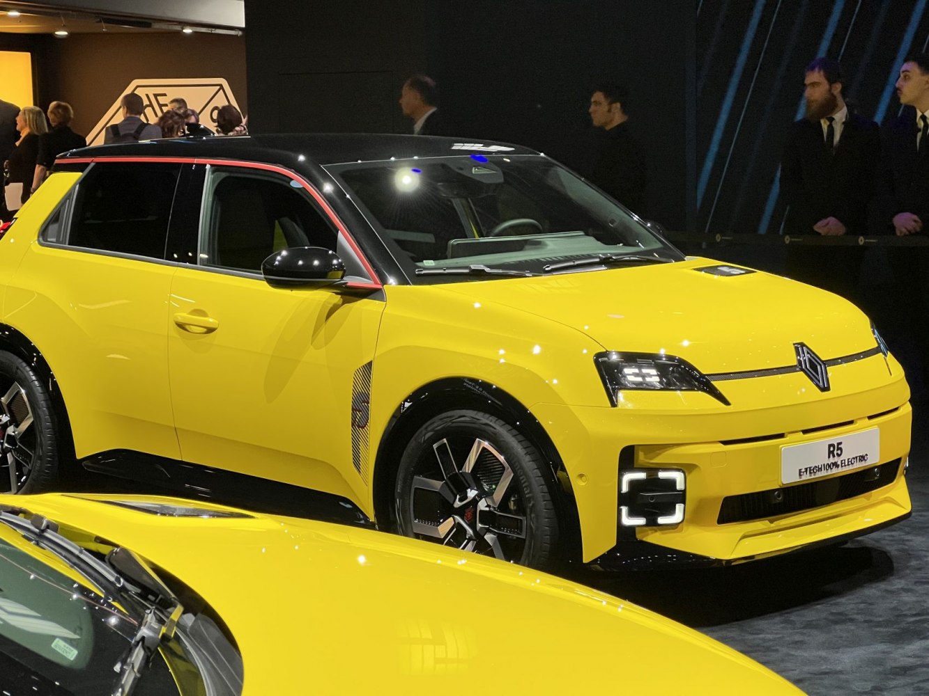 Yellow and black electric hatchback with LED lights and modern wheels