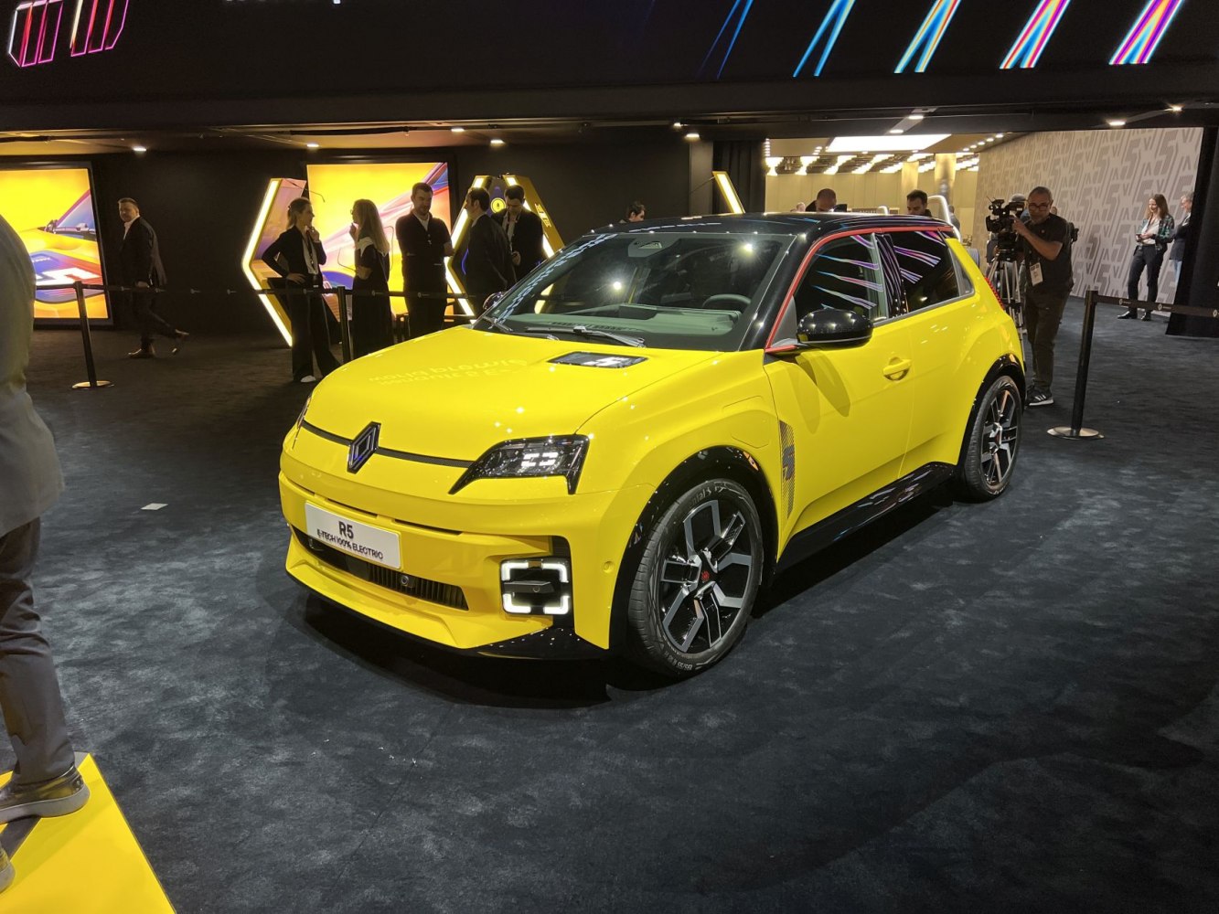 Yellow electric hatchback with LED headlights and sporty aerodynamic design
