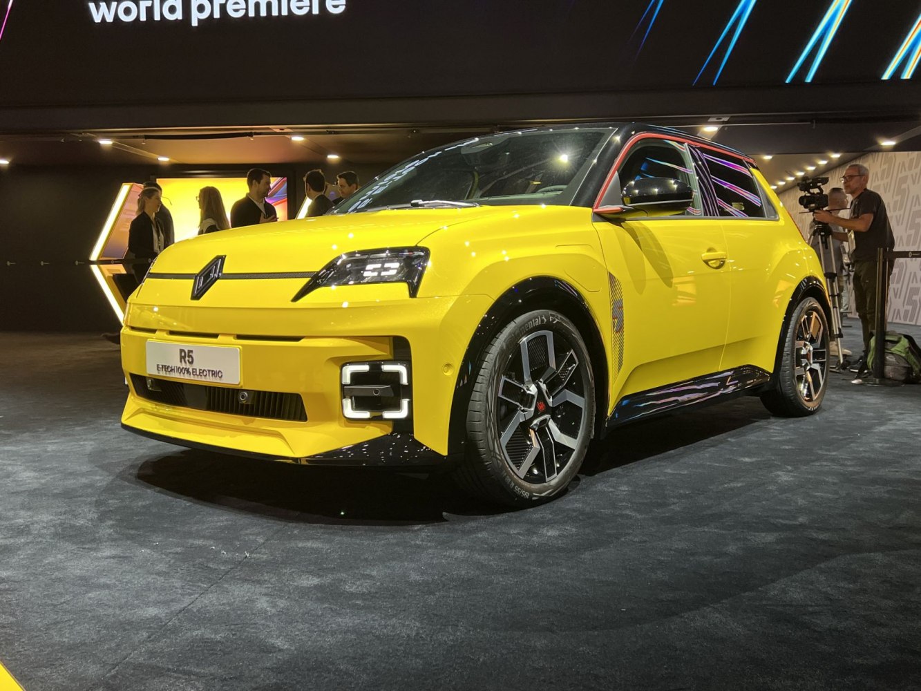 Yellow electric compact SUV front with modern LED headlights and distinctive grille.