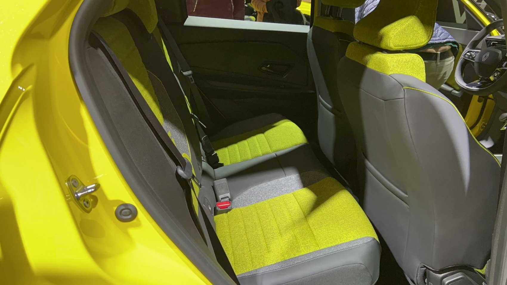 Yellow and gray rear seats with fabric upholstery and seat belts