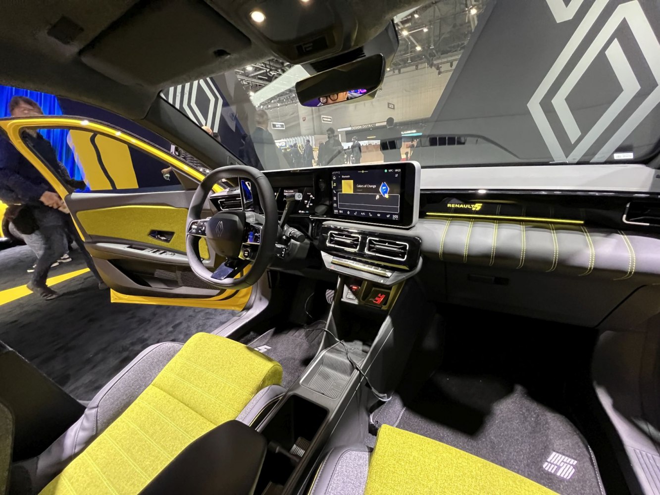 Car interior with digital dashboard, touchscreen, and yellow upholstery