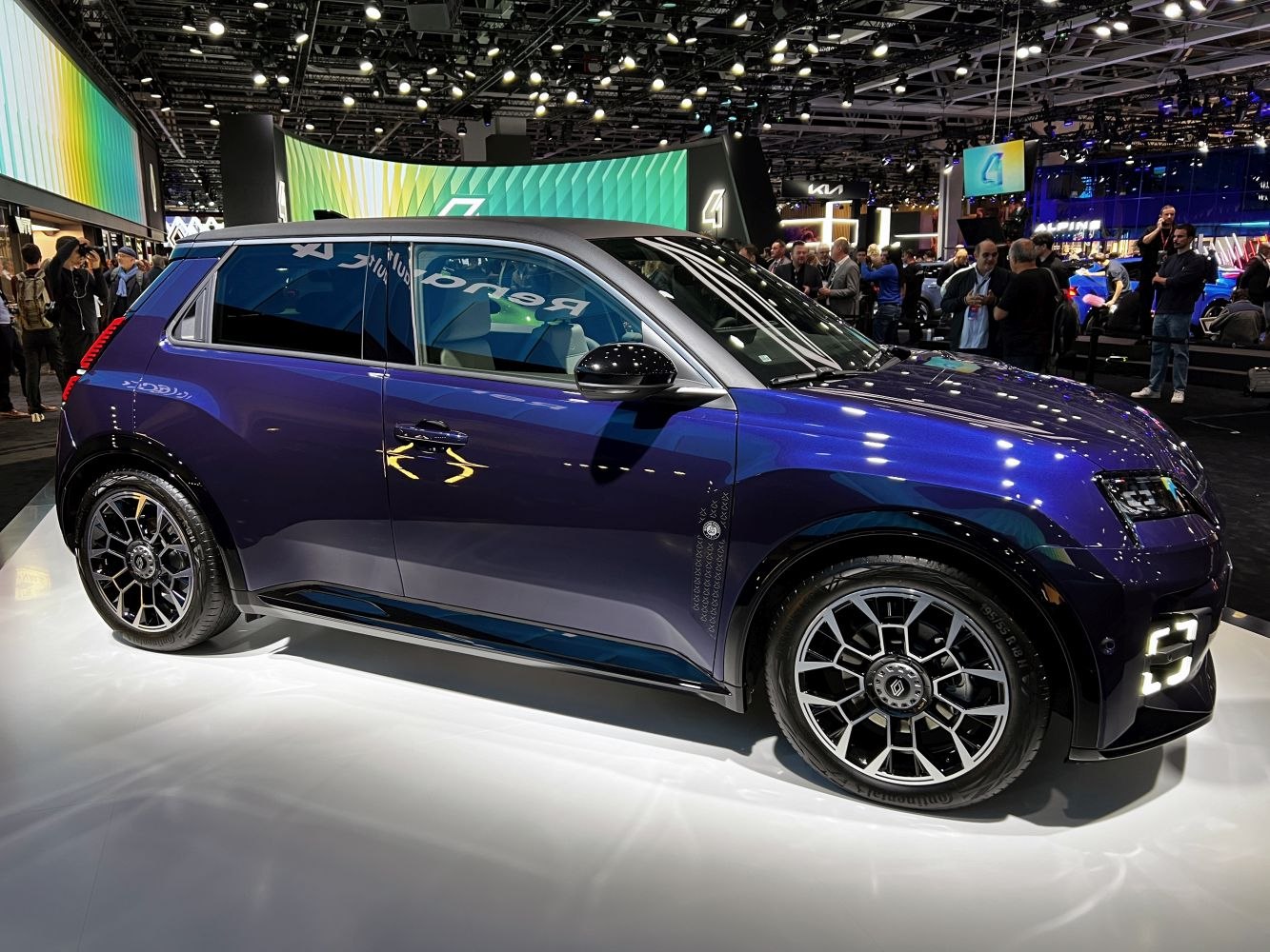 Side profile of modern electric hatchback with black roof and detailed wheels