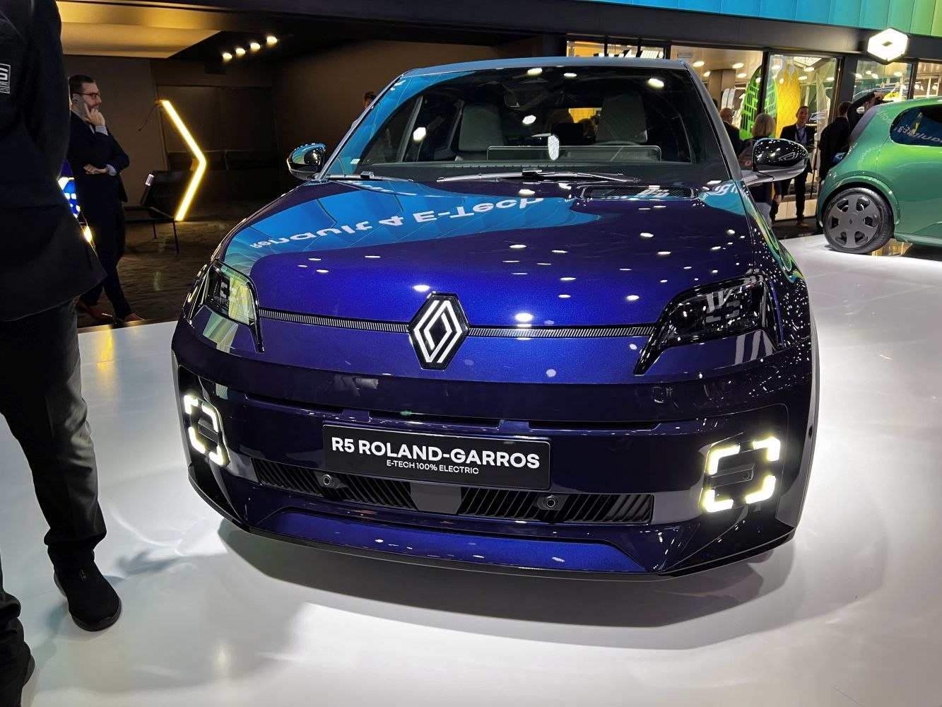Front view of a 2024 compact electric vehicle with distinctive LED headlights