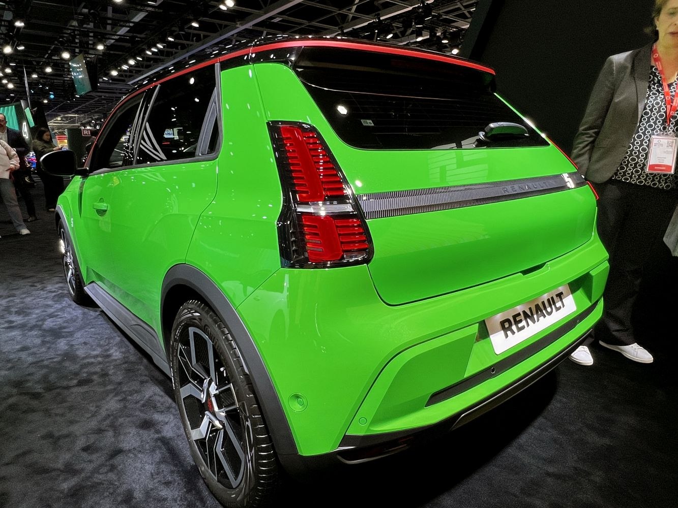 Bright green hatchback rear with vertical taillights and multi-spoke alloy wheels
