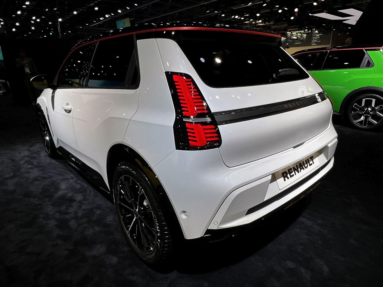 Rear view of a hatchback with distinctive vertical tail lights and sporty black wheels