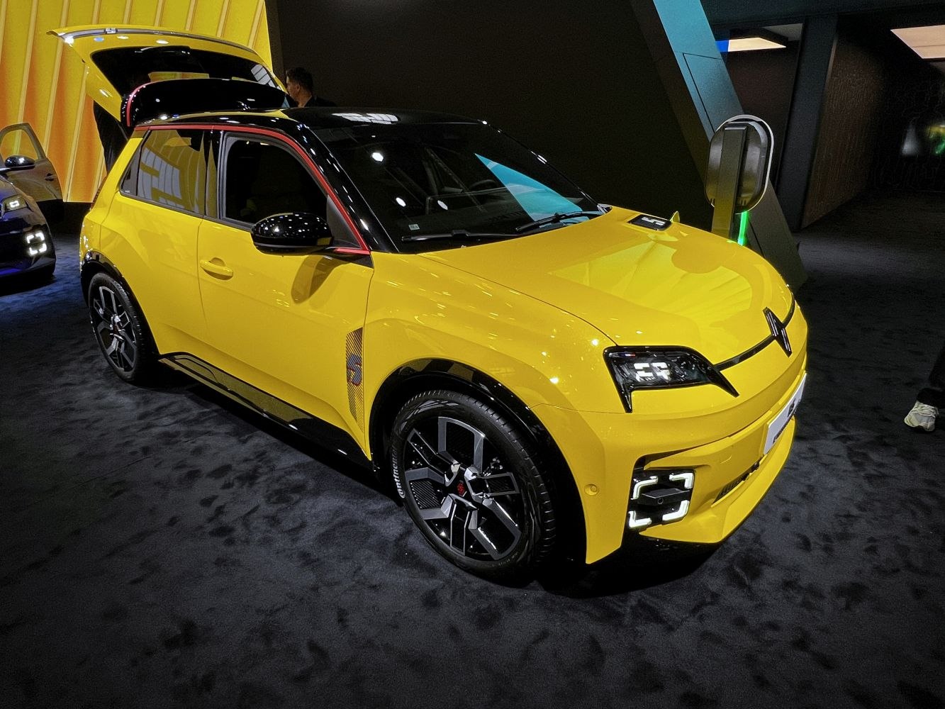 Yellow electric SUV with sharp LED headlights and multi-spoke alloy wheels