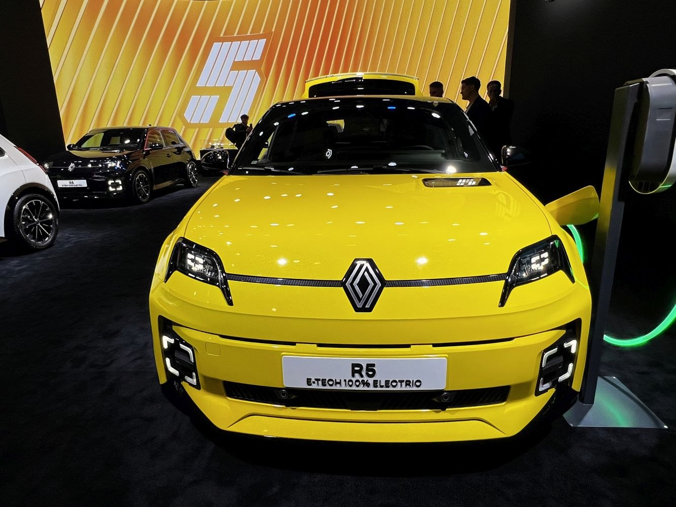 Front view of yellow electric hatchback with distinctive LED headlights