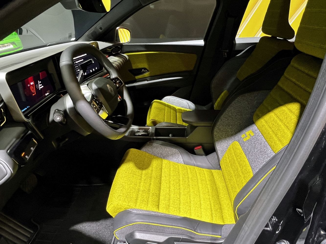 Modern interior with yellow-gray seats and digital dashboard