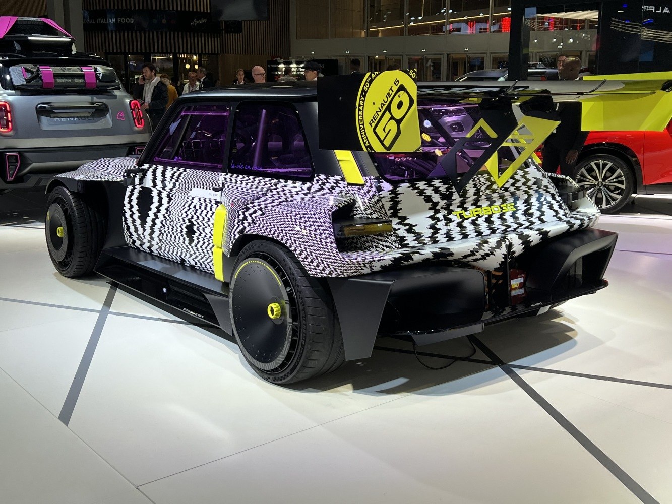 Bold black-white camouflage, large rear wing, aerodynamic wheel covers