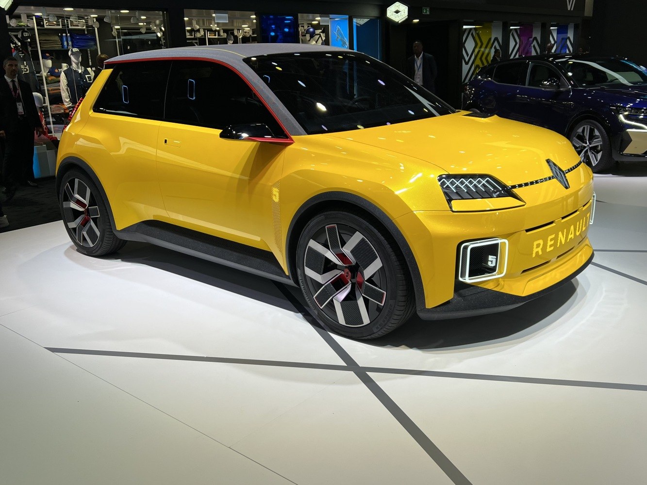 Yellow electric hatchback with innovative LED lights and aerodynamic wheels