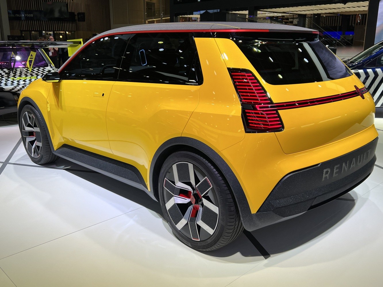 Yellow prototype compact with distinctive rear lights and aerodynamic wheels