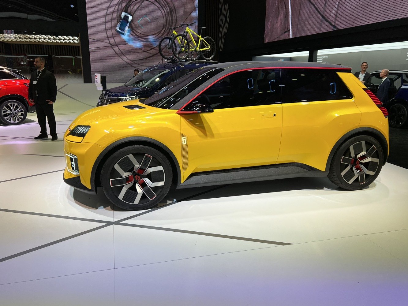 Yellow electric hatchback with futuristic design and unique wheels