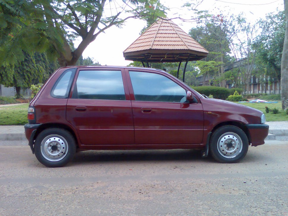 Compact hatchback side profile with steel wheels and four-door layout