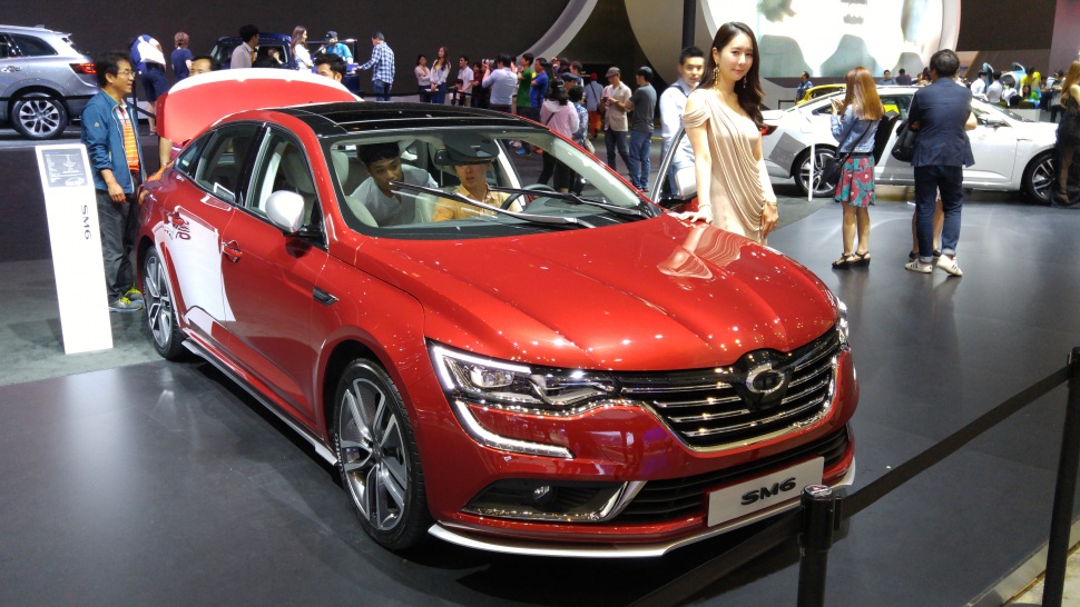 Front view of red sedan with detailed grille and headlight design.