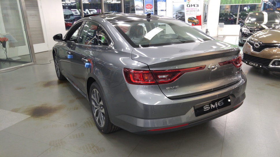 Rear and side profile with taillights and sleek sedan body.