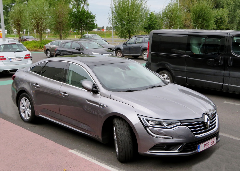 Front side view of a modern sedan with sleek headlights and smooth body lines