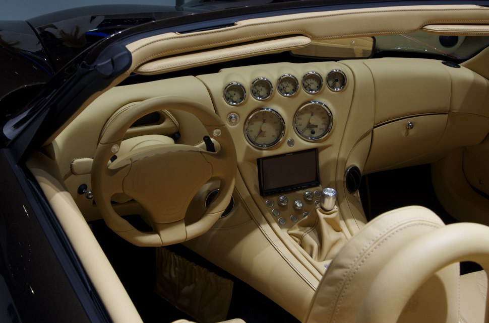 Beige leather interior with vintage-style dashboard and analog gauges.