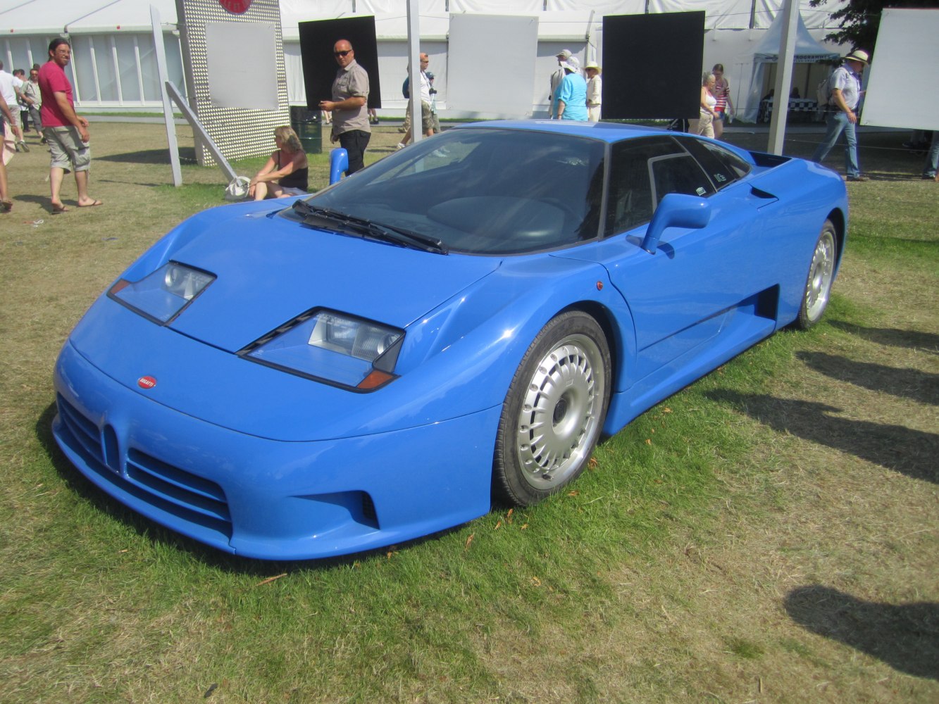 Blue sports car with pop-up headlights and turbine-style alloy wheels
