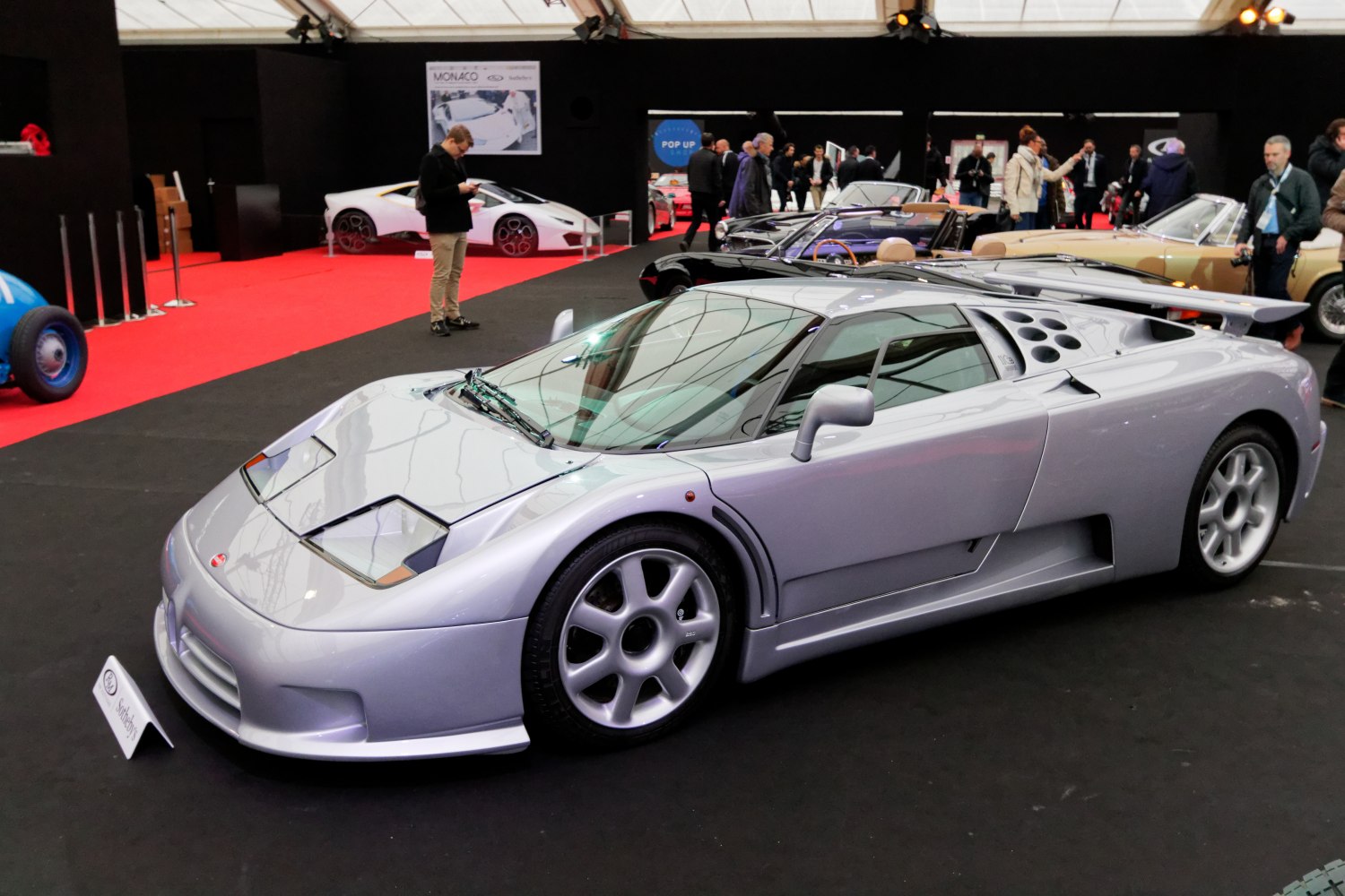 Silver sports coupe with rear wing and pop-up headlights