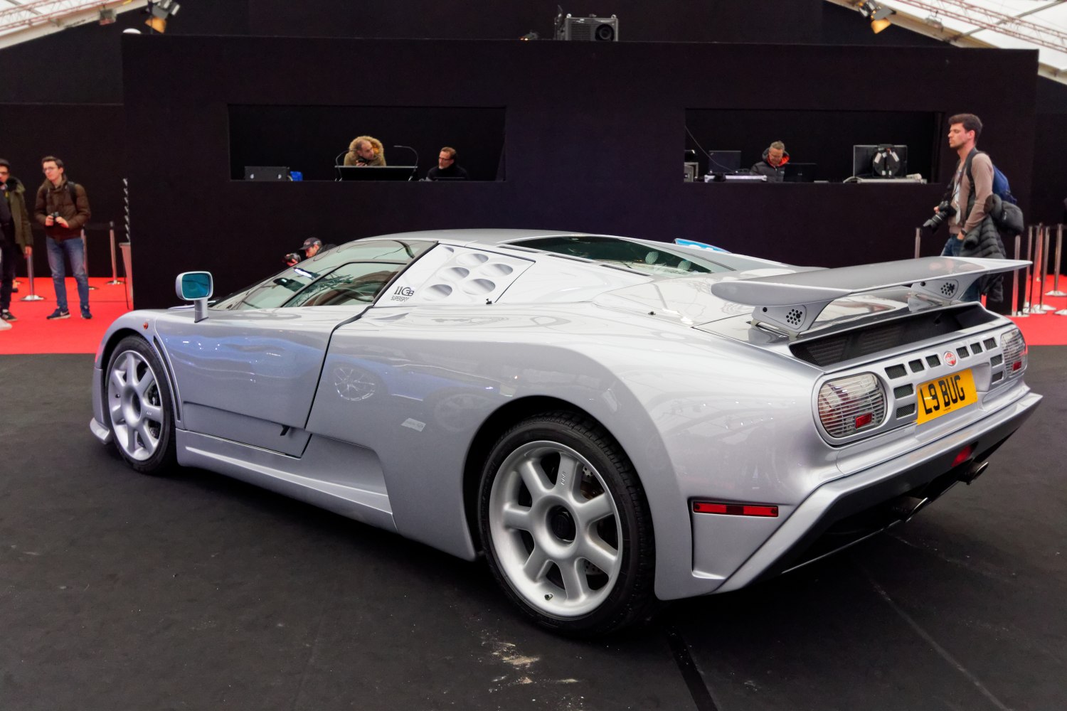 Silver sports car with rear wing and vented side panels