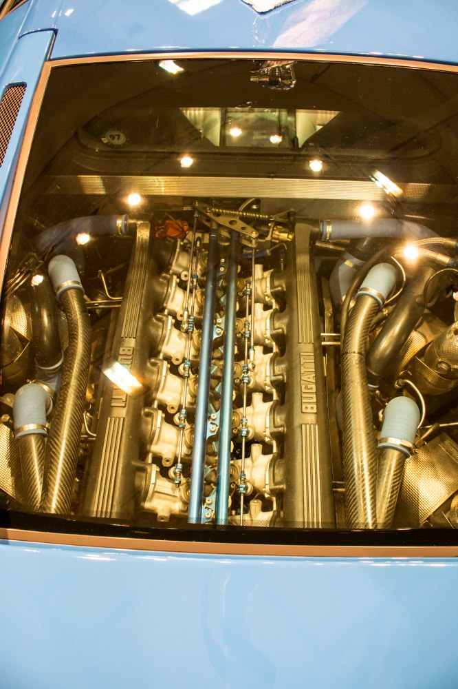 V12 engine with carbon fiber tubing under glass cover