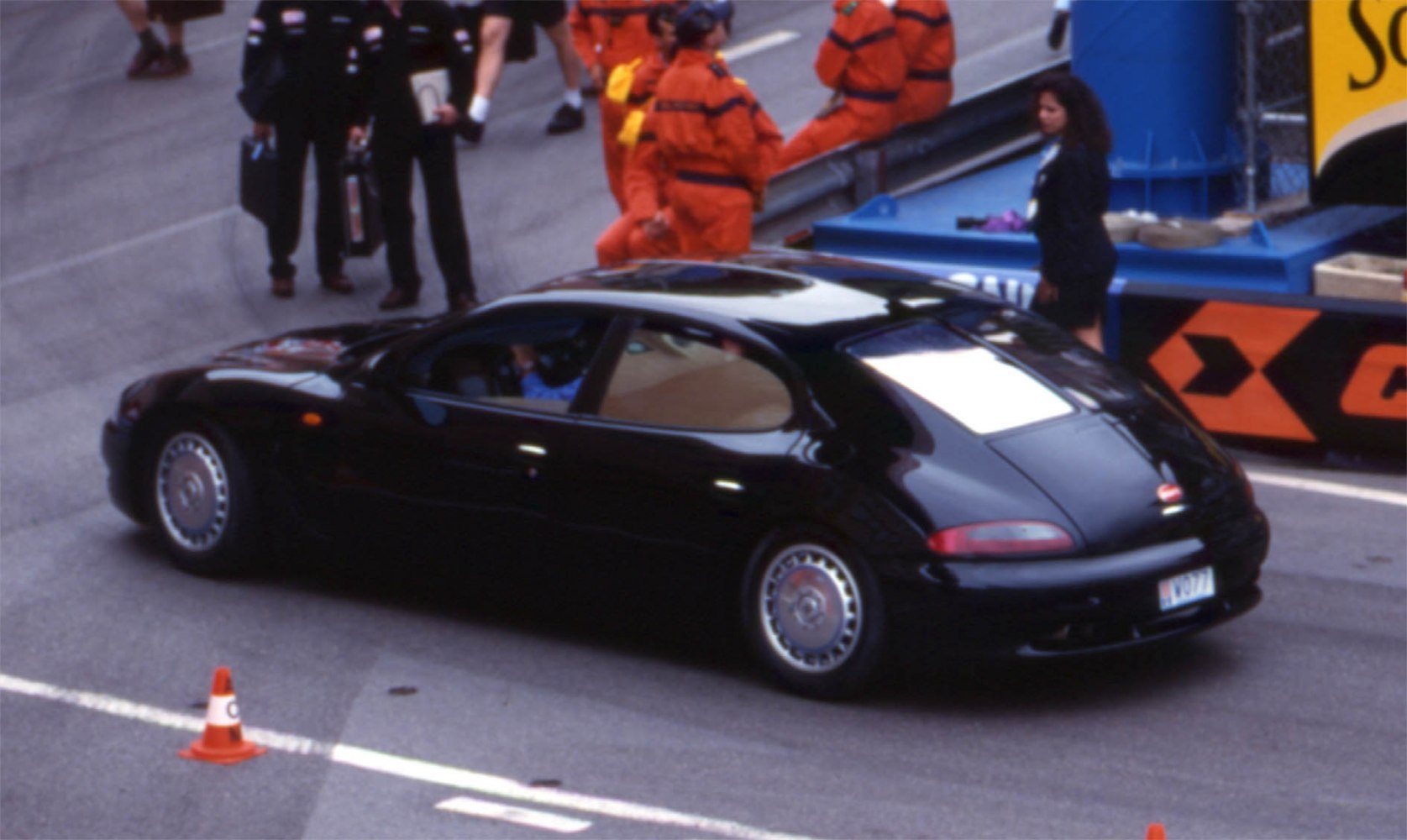 Sleek black luxury sedan with distinctive rear window and alloy wheels.