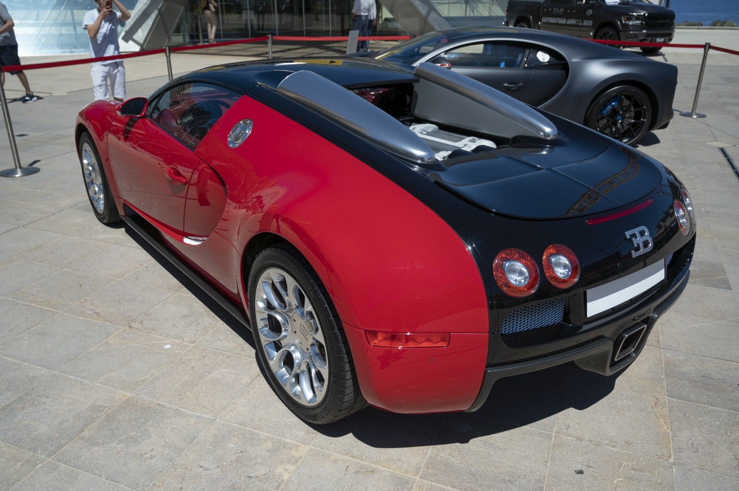 Red and black rear side with exposed engine cover and alloy wheels