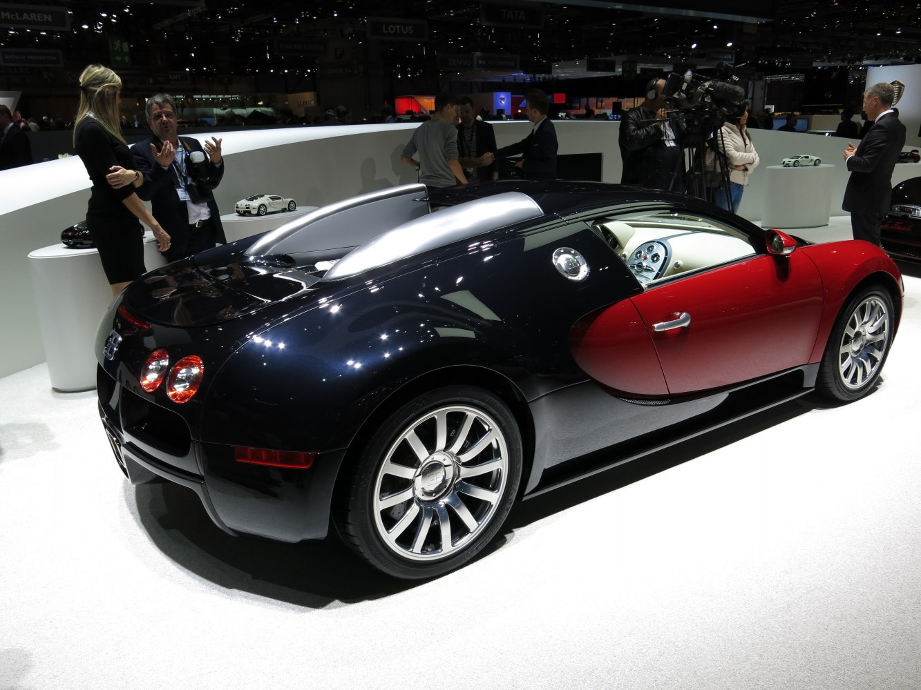 Rear side view of a two-tone luxury sportscar with alloy wheels.