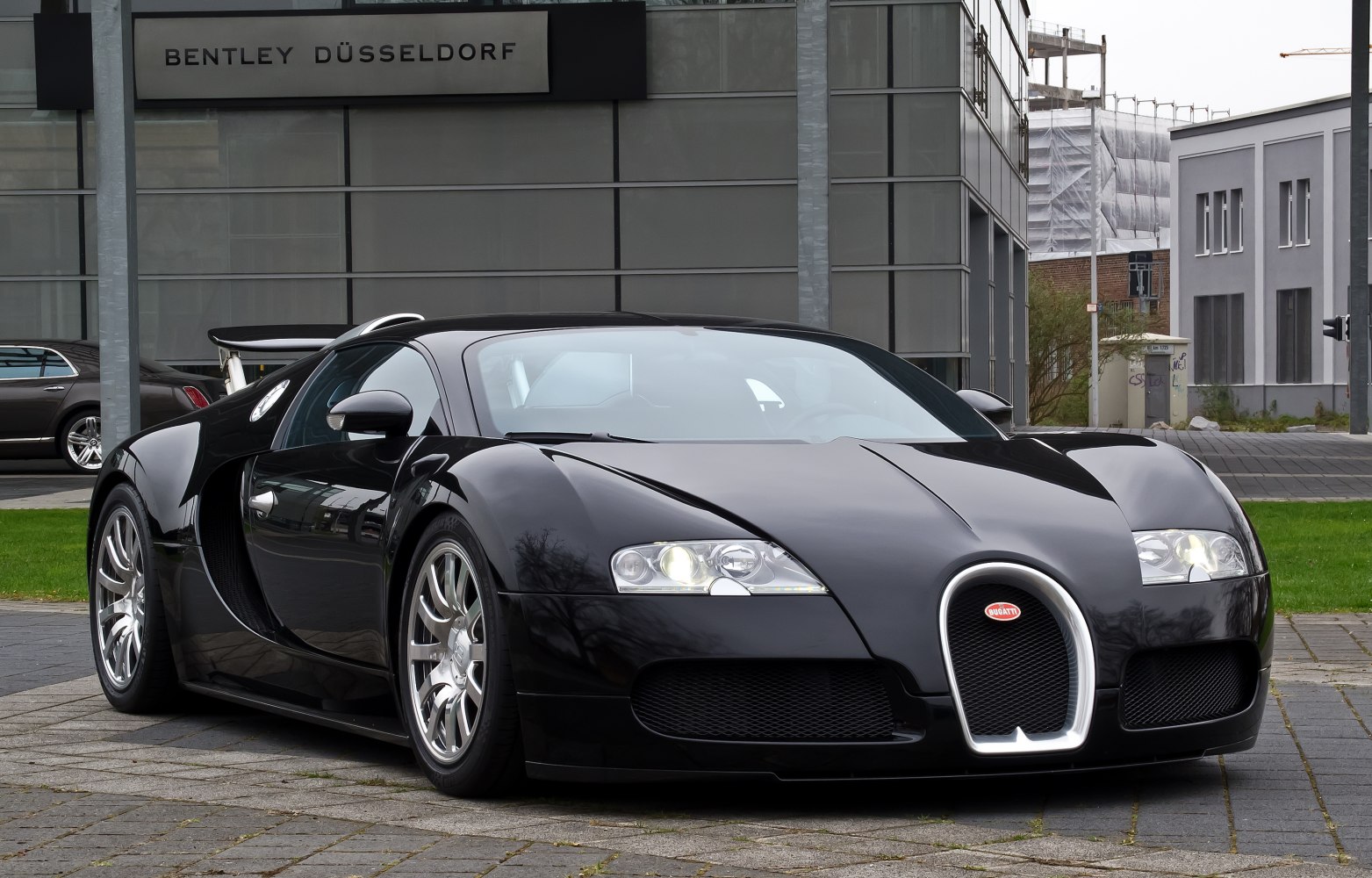 Front view of black sleek luxury coupe with distinctive grille and aerodynamic shape