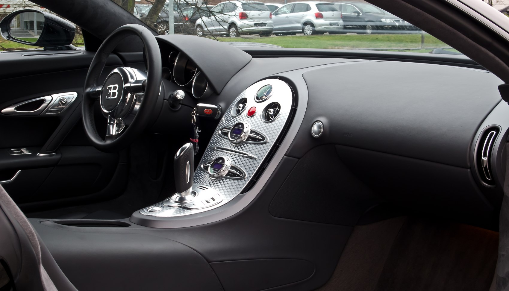 Luxury car interior with steering wheel and detailed dashboard panel