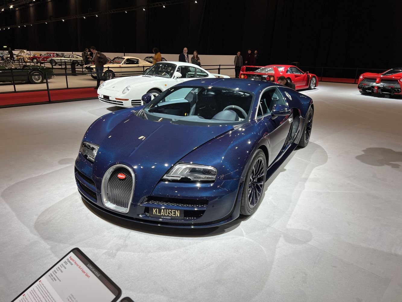 Front and side view of blue carbon fiber luxury coupe with aerodynamic design