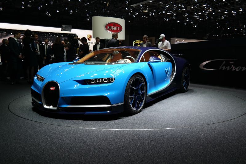 Blue and black hypercar with aerodynamic design and LED headlights.