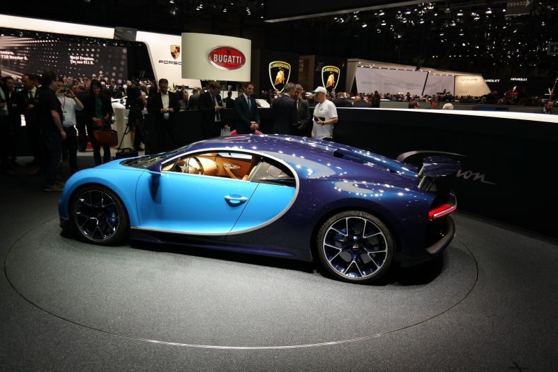 Two-tone blue luxury sports car with rear spoiler side profile