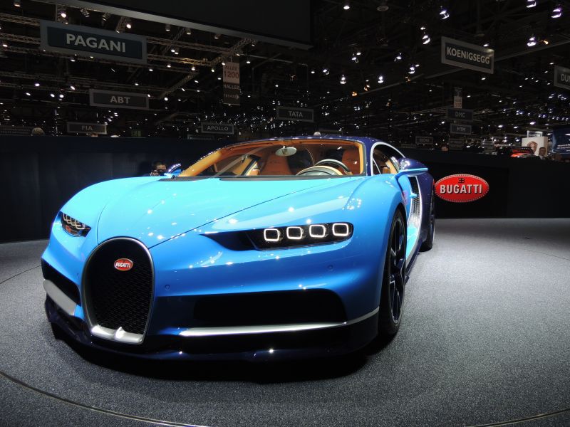 Front view of a luxury sports car with quad LED headlights and horseshoe grille