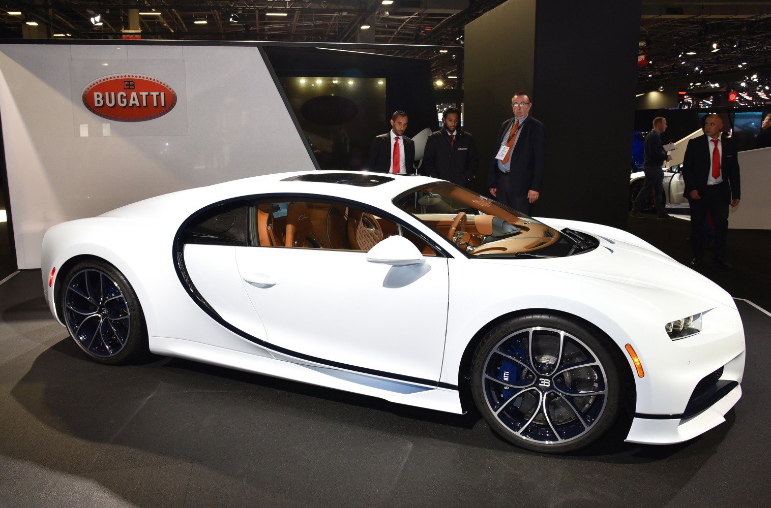 White sports coupe with black-rimmed wheels and tan leather interior
