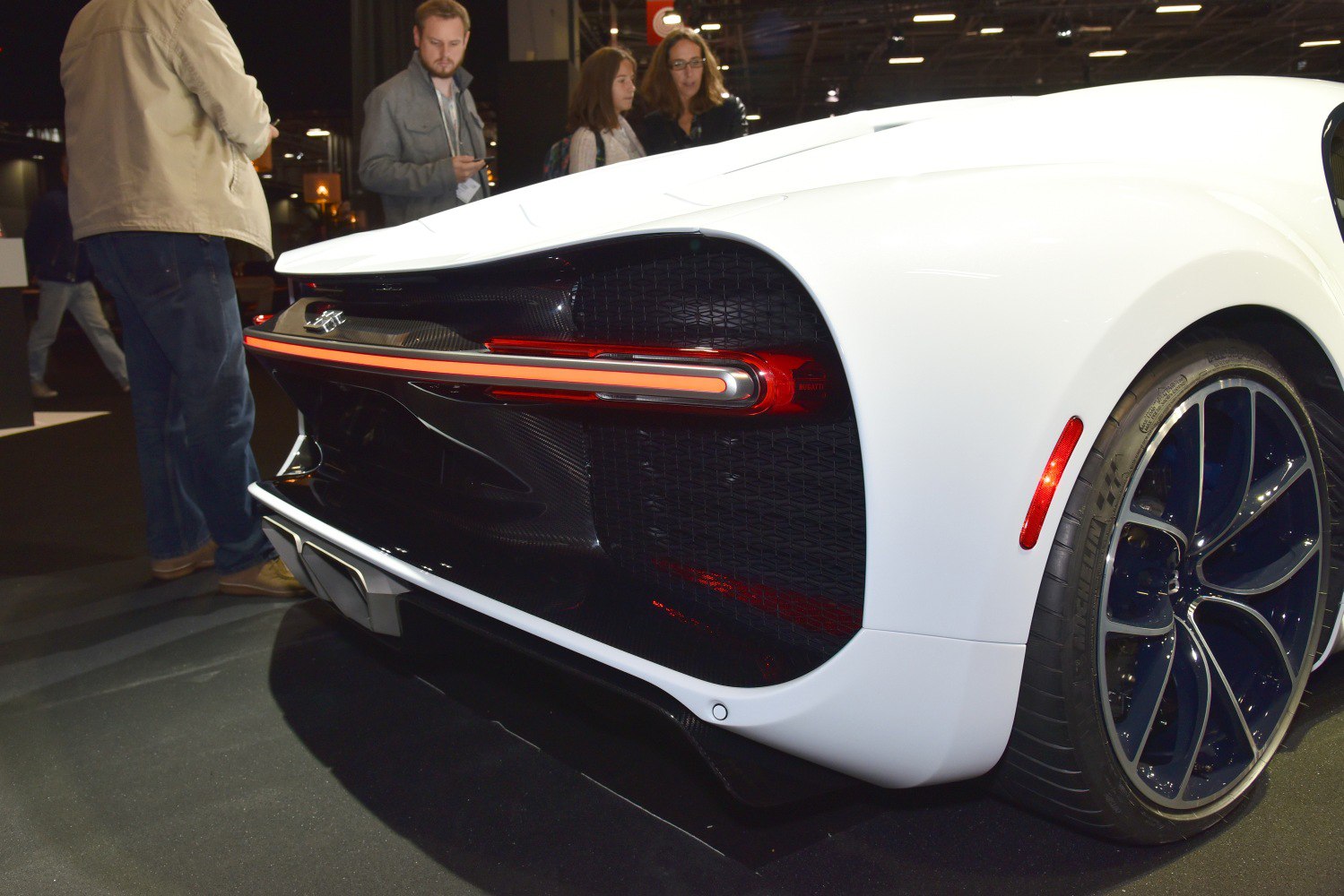 Close-up of rear light and wheel detail on white luxury hypercar.