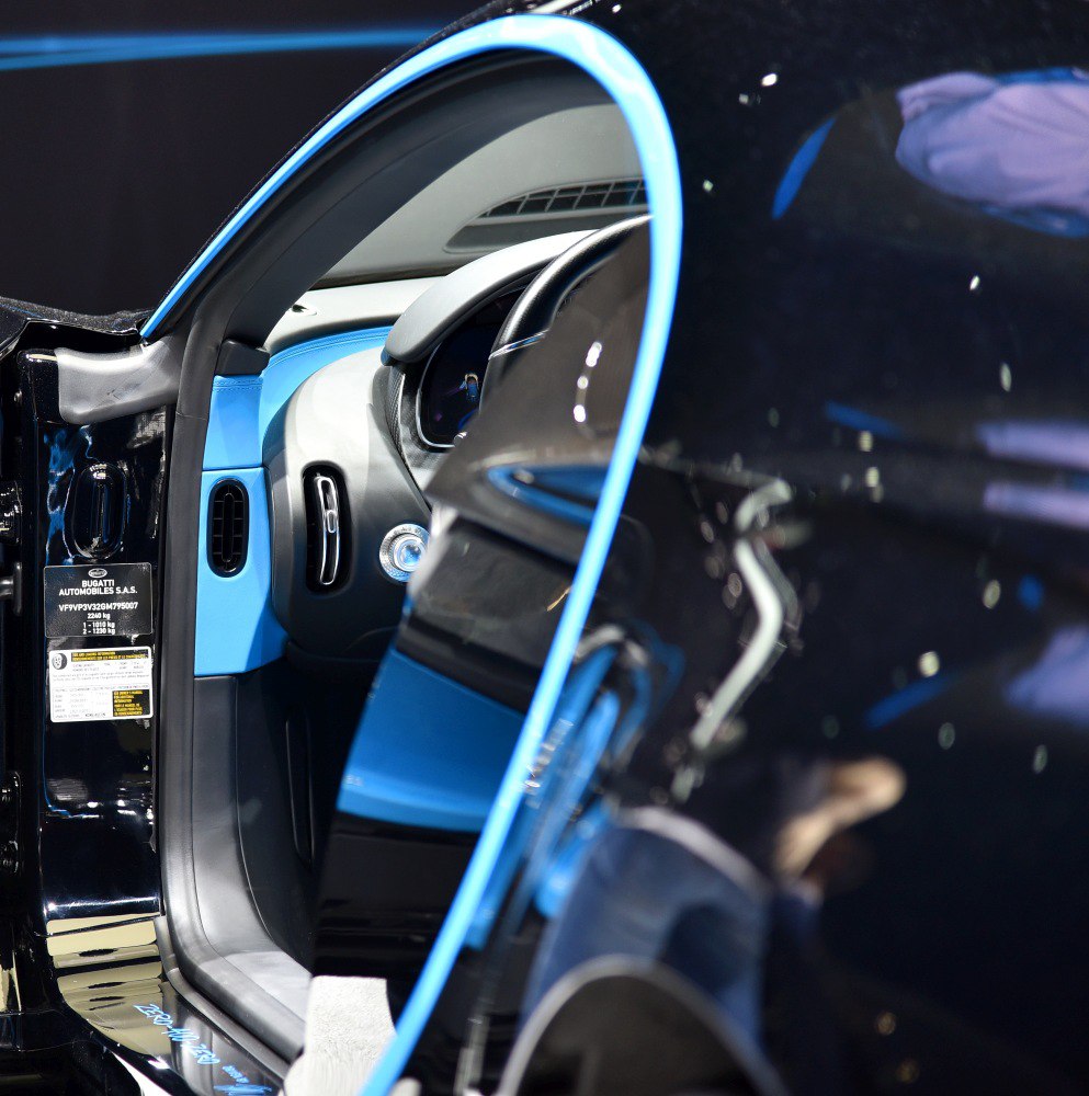 Close-up of luxury car interior with blue dashboard and trim accents