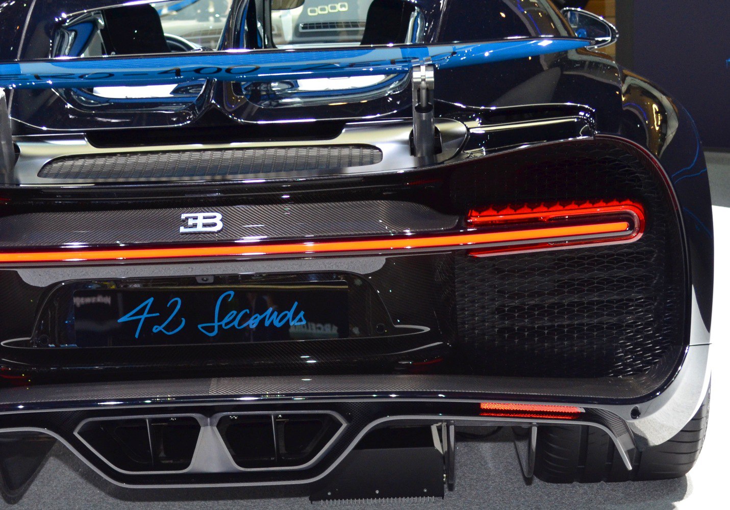 Rear of a high-performance sports car with LED taillight strip and diffuser.