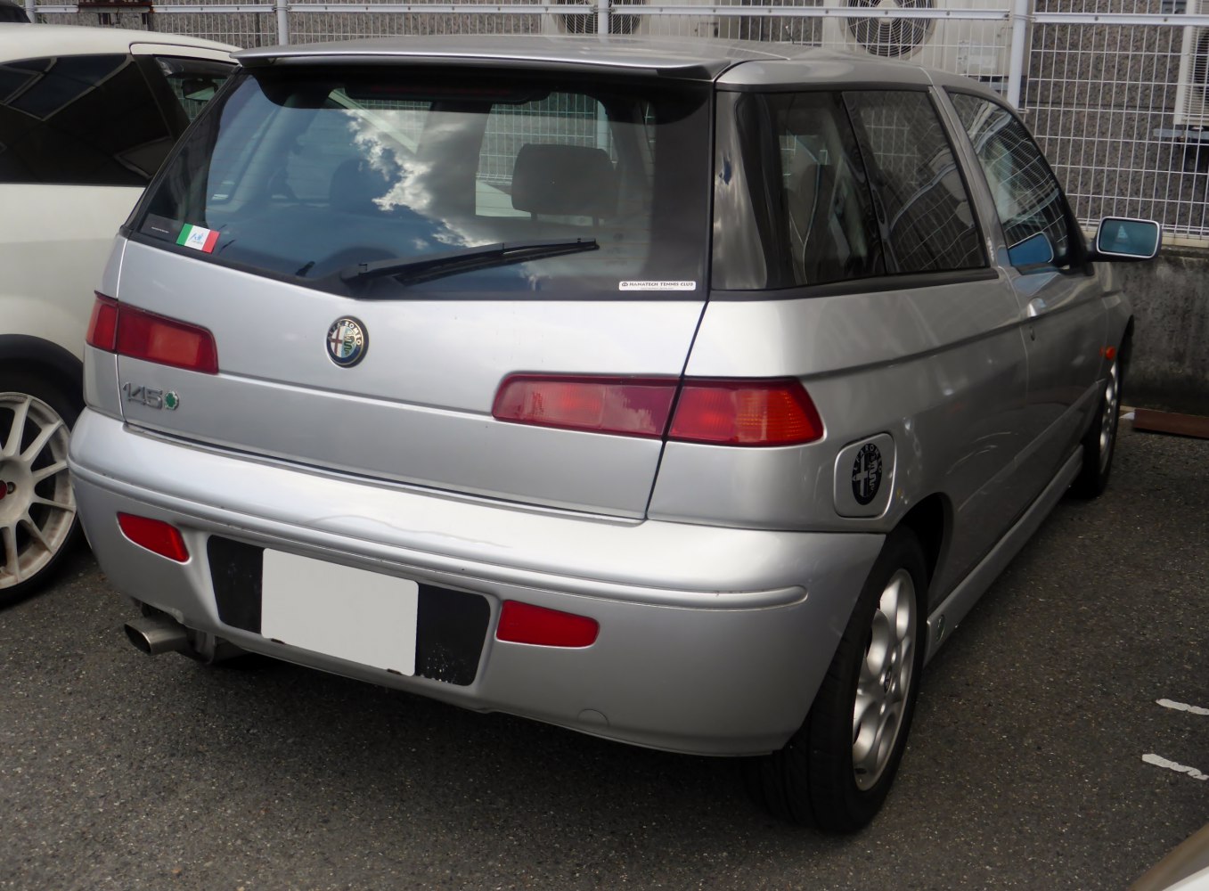 Rear view of a classic compact hatchback with distinctive taillights.