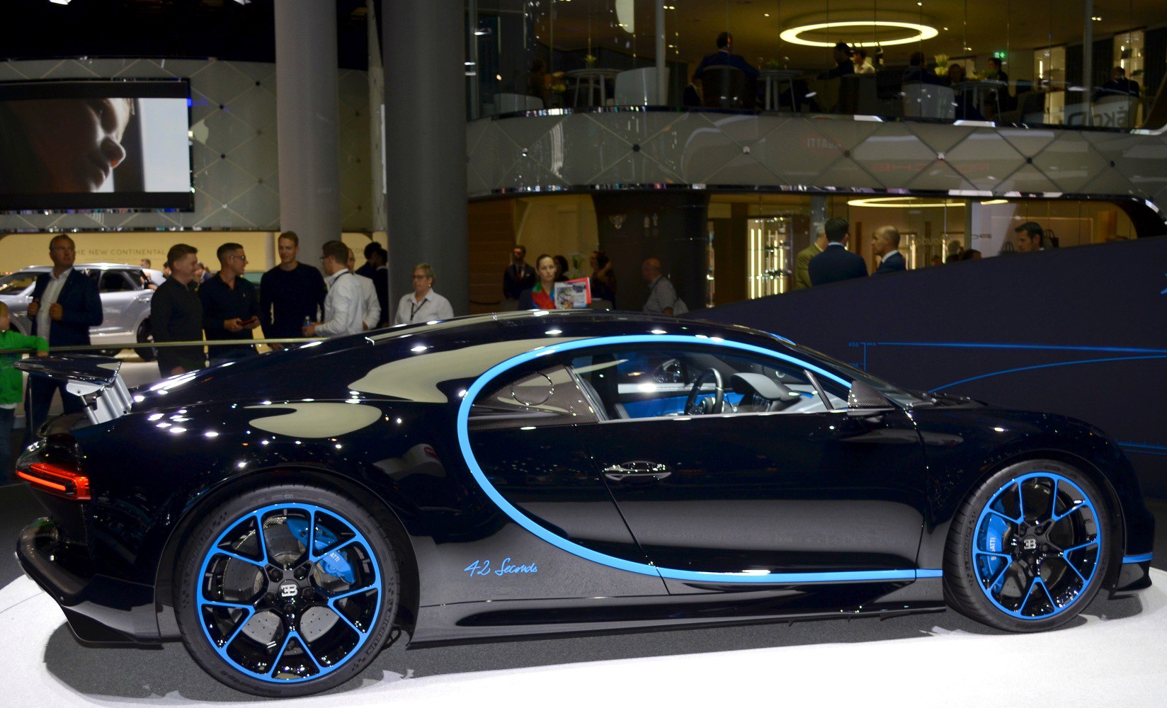 Side view highlighting blue accents and distinctive alloy wheels.