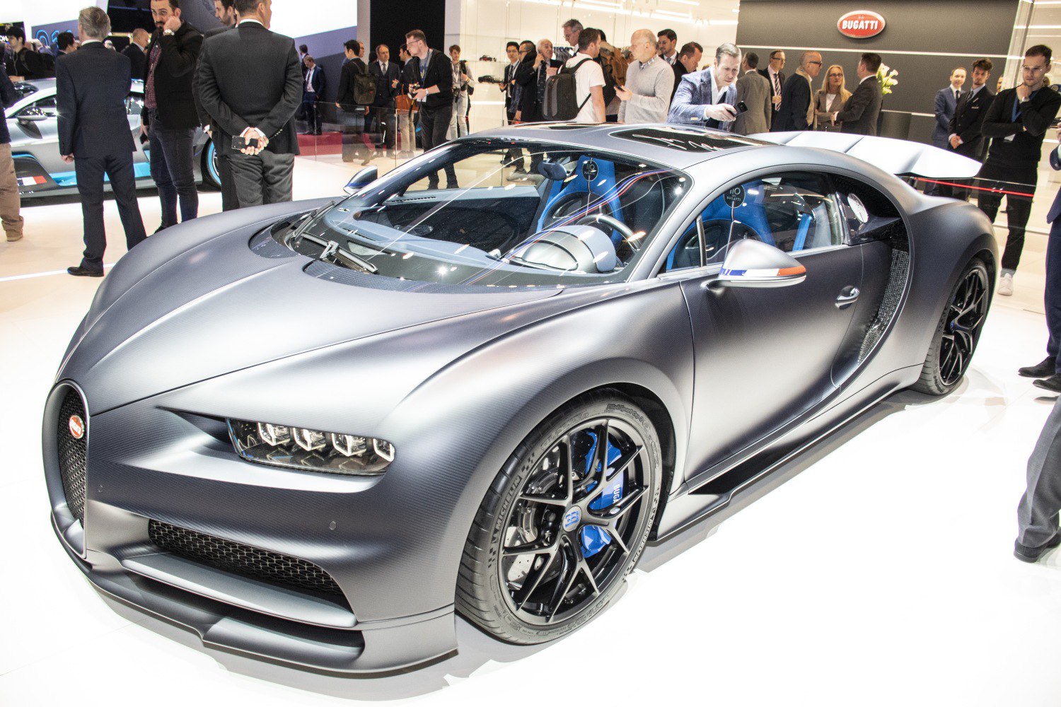 Sleek aerodynamic hypercar front and side view with racing wheels and blue accents