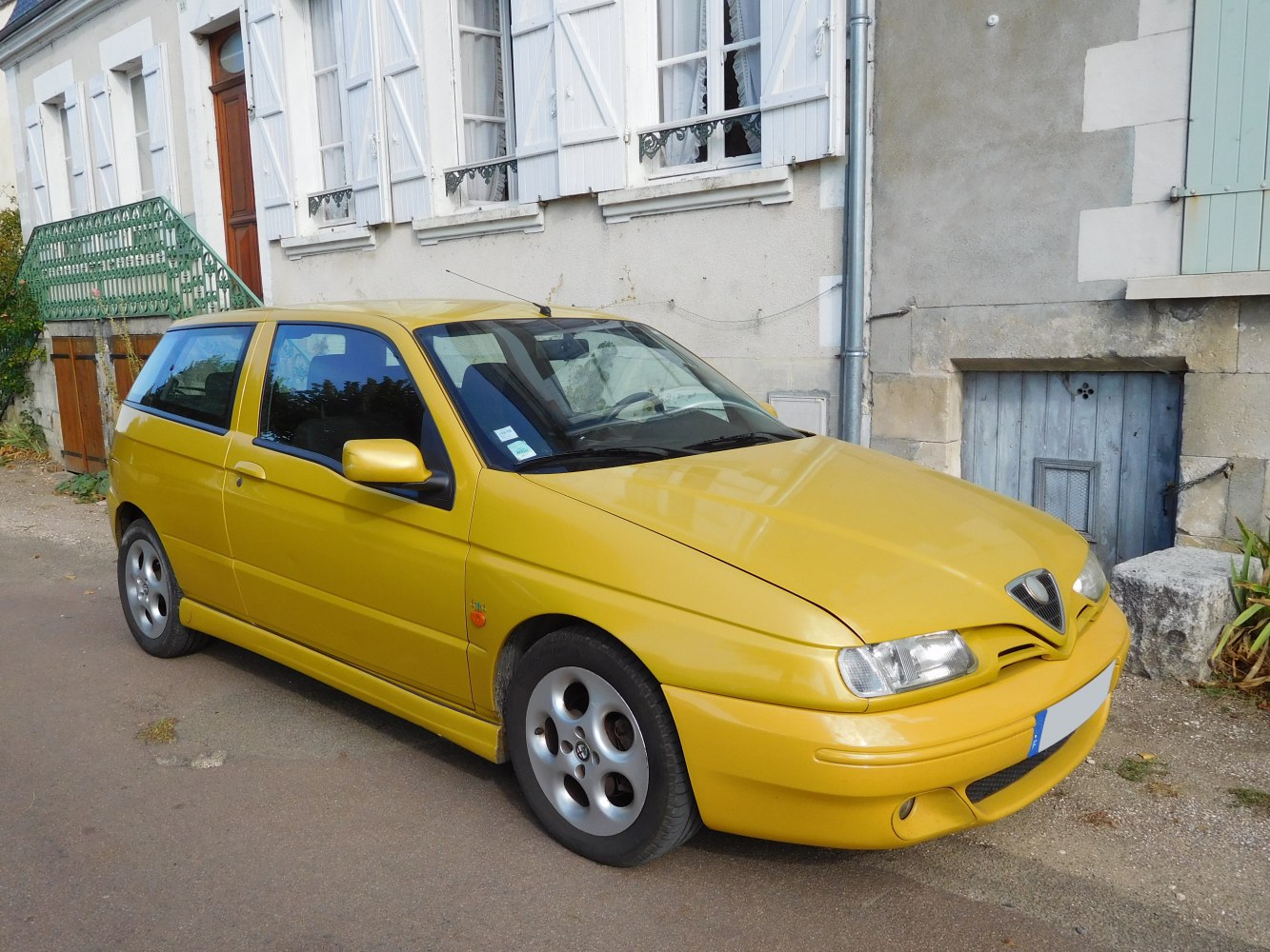 Yellow compact hatchback with rounded headlights and unique front grille