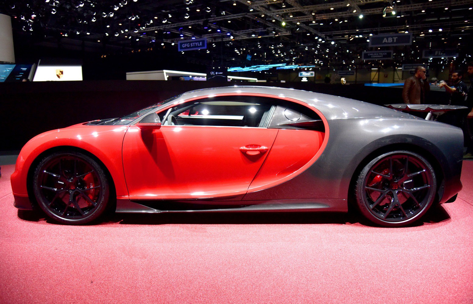 Red sport coupe with carbon fiber rear section and large racing wheels