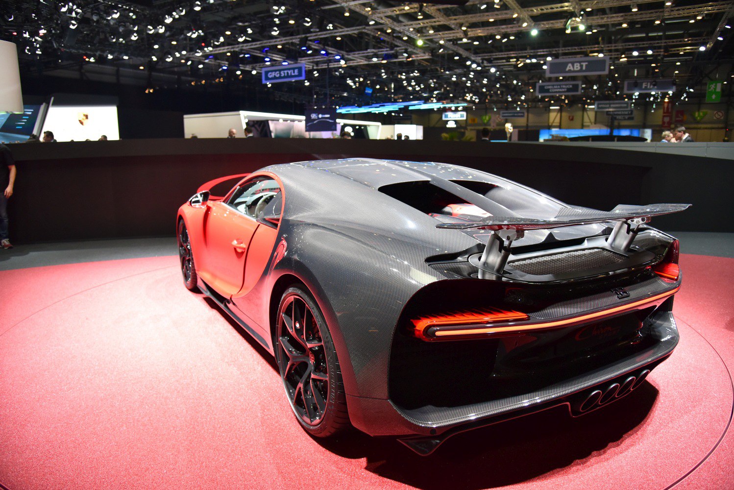 Rear 3/4 view sports car with carbon fiber body and large rear wing
