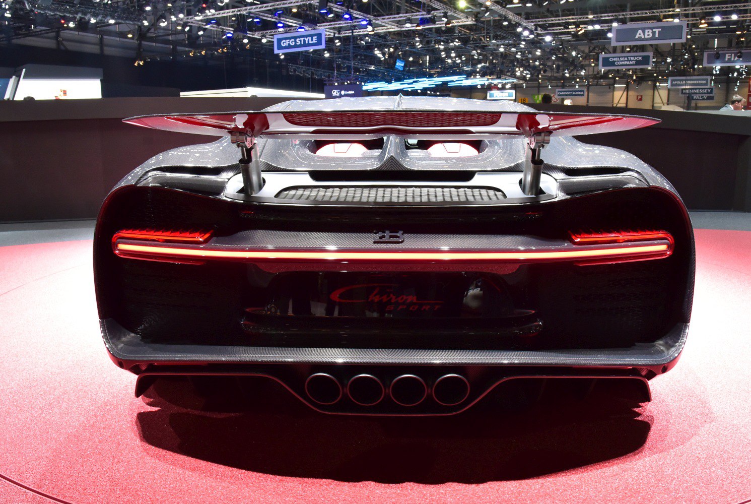 Active rear spoiler and quad exhaust tips of a hypercar rear end