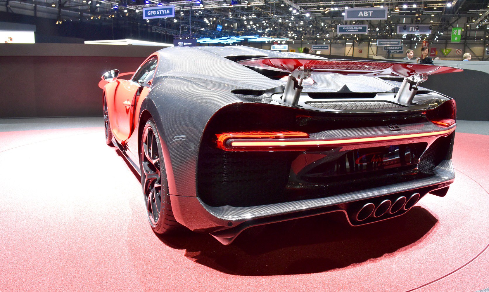 Rear with active spoiler, quad exhausts, sculpted diffuser, and LED taillights