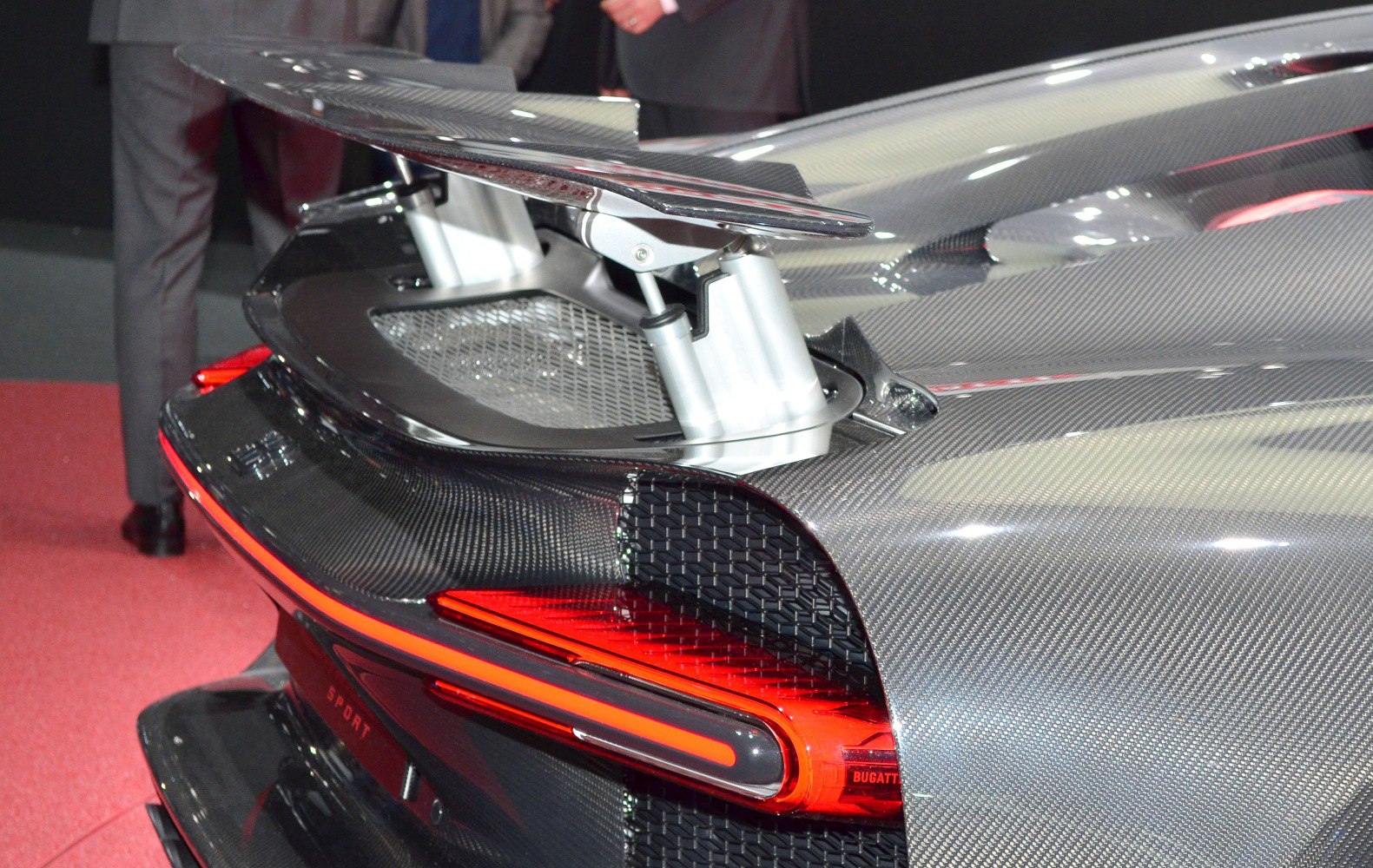 Close-up of rear spoiler and tail light with carbon fiber body panel