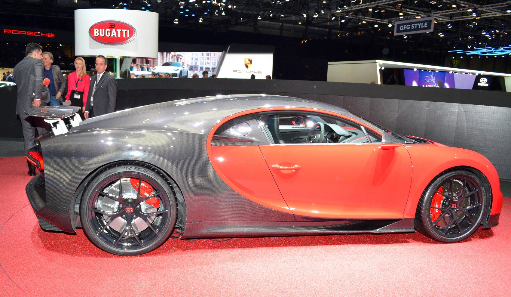 Side profile with carbon fiber body and red doors, black sporty wheels