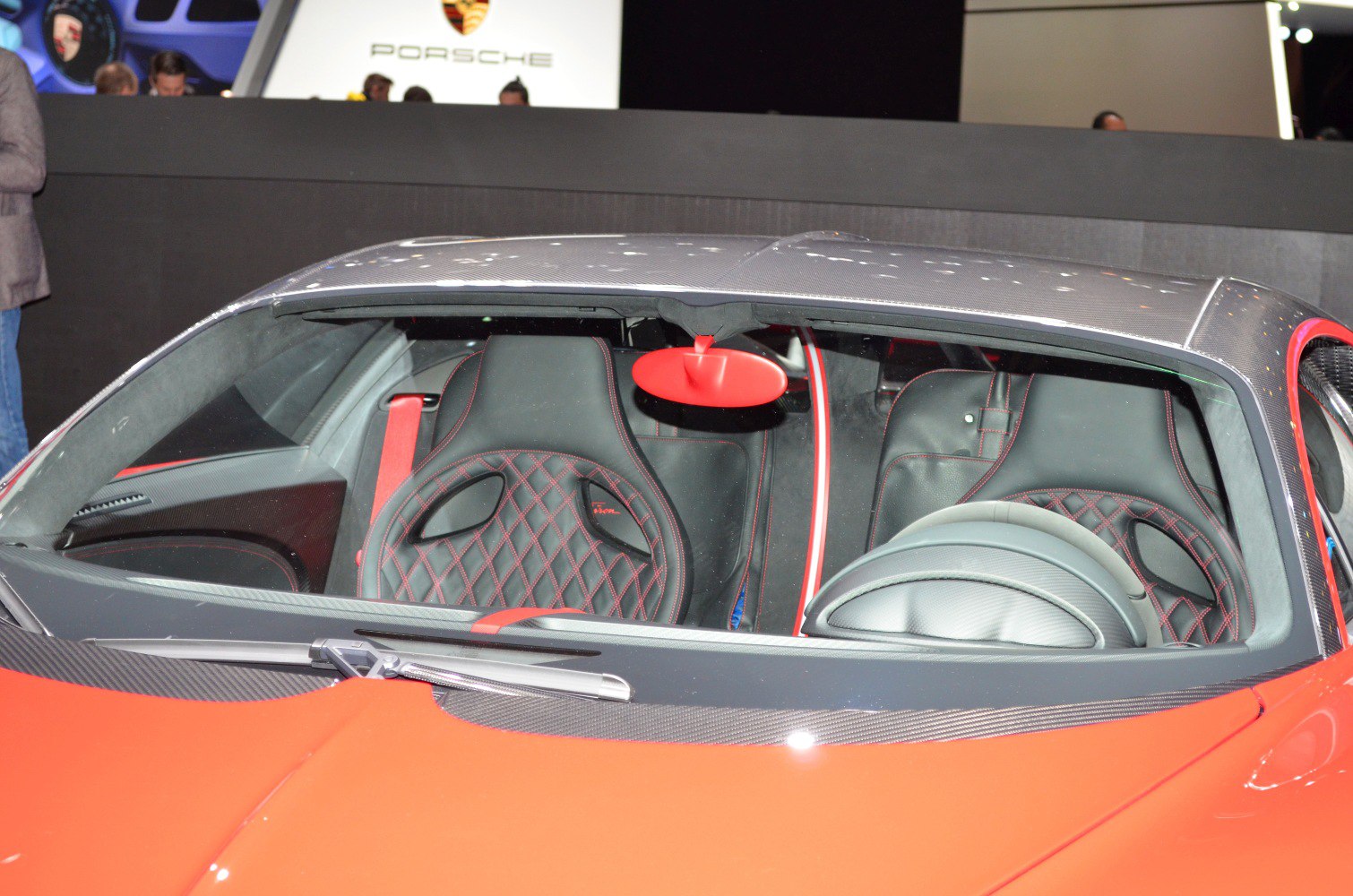 Quilted leather seats with a unique red rearview mirror inside luxury sports car