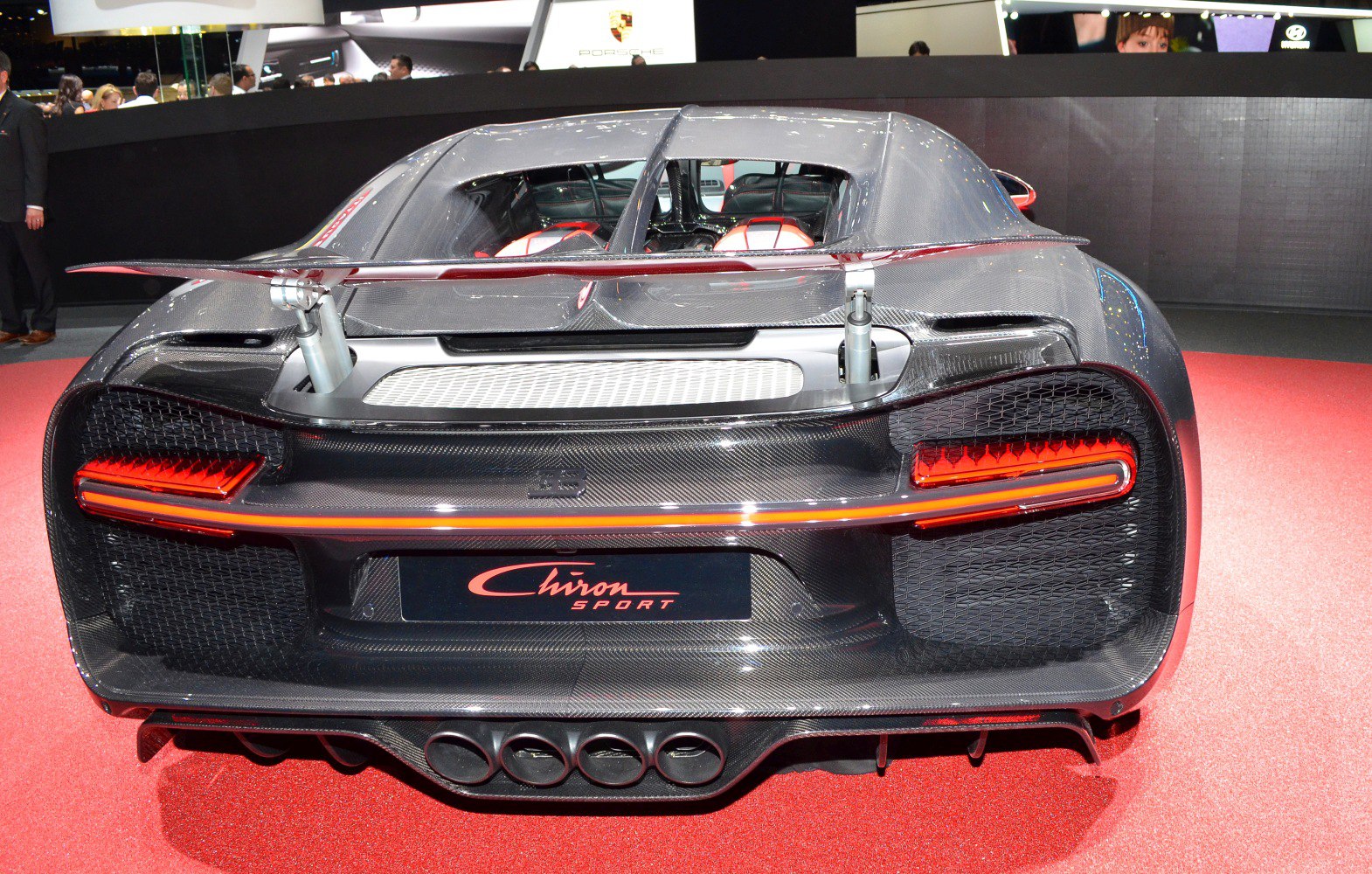 Rear view of a supercar with carbon fiber, LED tail lights, and quad exhaust.